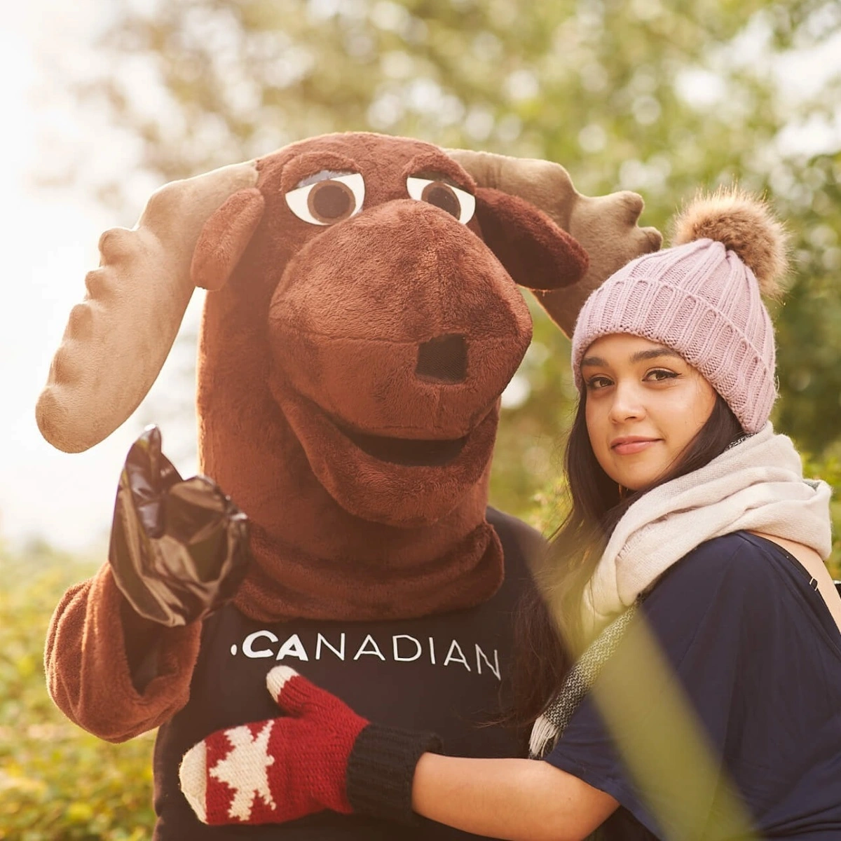 A girl hugging a moose